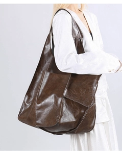 Detail view of the deep brown vintage faux leather tote bag with side patch pocket