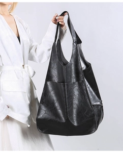 Close-up of black retro soft leather tote bag showing large capacity and handle details