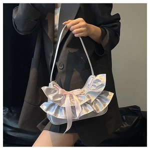 Detail of silver satin underarm bag with pink silk bow and ruffled mesh design