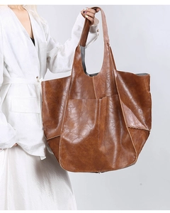 Detailed view of stitching and texture on vintage brown soft leather tote bag