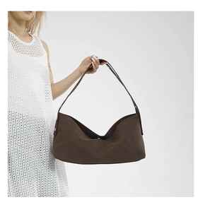Detail view of dark brown crescent hobo bag with silver rivets and matte texture finish