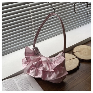 Detailed view of pink satin ruffled shoulder bag with a ribbon bow and half-moon shape