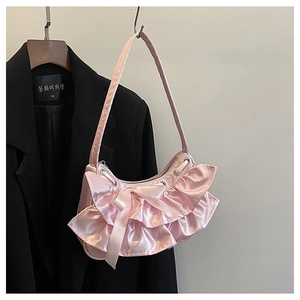 Detail of pink satin hobo bag with tiered ruffles and a central ribbon bow decoration