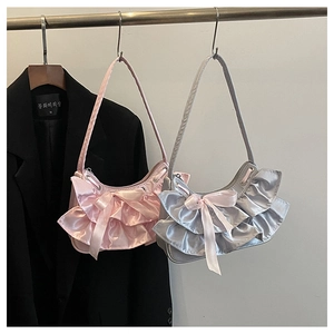 Detail of satin hobo bags with ruffle layers and bow in pink and silver grey colors