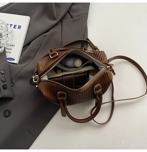 Interior view of brown pleated bucket bag showing capacity for daily essentials