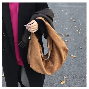 Brown suede hobo tote bag featuring double metal zippers and wide shoulder strap