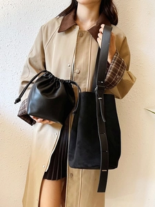 Minimalist black suede and leather bucket tote bag with wide shoulder strap for women