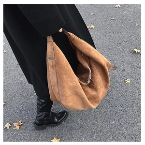 Brown suede tote bag shown on shoulder with autumn street style fashion aesthetic