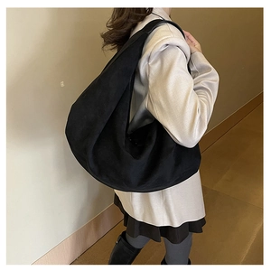 Minimalist black hobo shoulder bag in soft suede fabric, large capacity tote on model side view