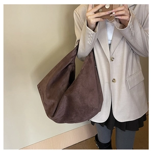 Detail of dark brown suede tote bag showing soft texture and large capacity for daily commute