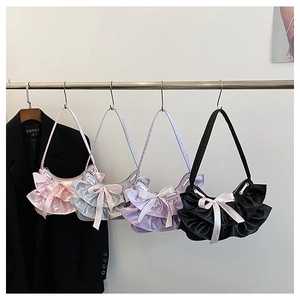 Detail view of ruffled satin shoulder bags in pink, silver, purple, and black colors