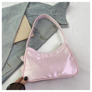 Detail of pink satin hobo bag featuring mesh patchwork and elegant semi-circular design