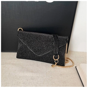 Macro view of rectangular envelope clutch bag with shimmering silver rhinestones