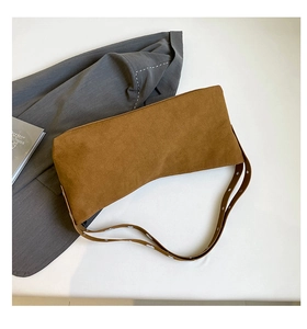 Detail view of brown matte suede texture on minimalist tote bag with silver grommet strap
