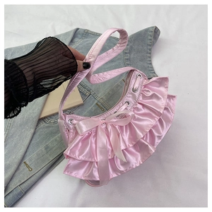 Detail of pink ruffled satin handbag with silk bow and silver metal eyelets
