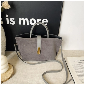 Close-up of matte grey tote bag with elegant golden metal buckle and sleek leather texture