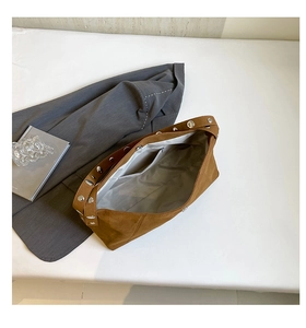 Internal view of brown suede crossbody bag with magnetic closure and zippered inner pocket