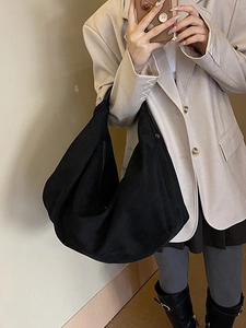 Minimalist black oversized hobo bag in soft suede-like texture for daily commuting