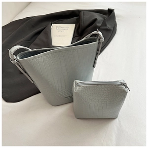 Detail of light blue crocodile pattern bucket bag set with matching zipper coin pouch