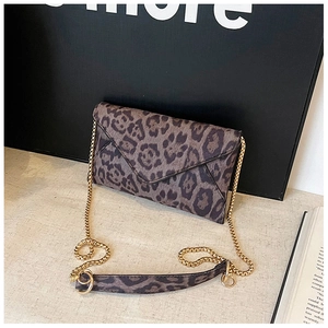 Detail of leopard print envelope clutch with gold metal chain strap and shoulder pad