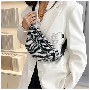 Detail of zebra pattern faux fur waist bag with double zippers and soft texture
