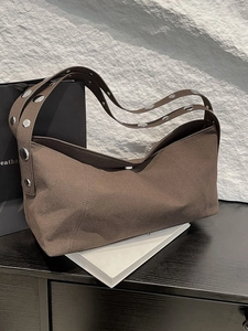 Coffee brown suede underarm bag featuring wide strap with large silver metallic studs