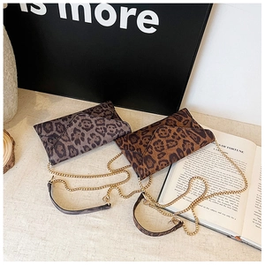Detail of leopard print envelope clutch bags with gold metal chain straps and leather pads