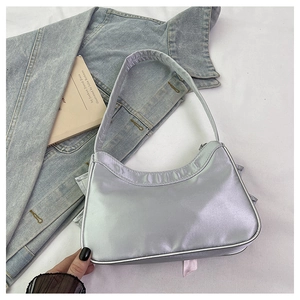 Detail of silver metallic hobo bag with zip closure and trendy Y2K minimalist design