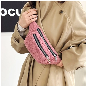 Detail of pink teddy fleece crossbody chest bag with double silver zippers on fuzzy texture