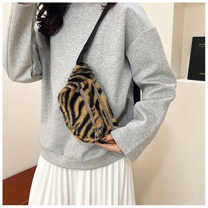 Detail of tiger print teddy fleece fanny pack with dual silver zippers and wide strap