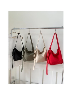 Detailed display of large canvas tote bags in four colors with adjustable metal buckles