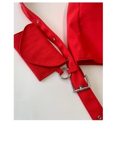 Detail of red canvas tote bag featuring wide eyelet strap and small clip-on pouch accessory