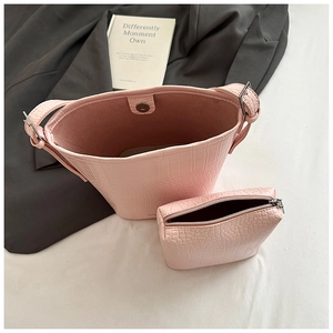 Detailed top view of pink crocodile embossed bucket bag set with matching inner pouch