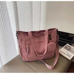 Detail of dusty rose nylon tote bag with wide straps and detachable round coin purse