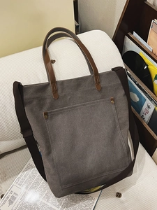 Vintage dark grey canvas tote bag with brown leather handles and adjustable shoulder strap