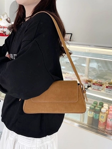 Brown matte suede underarm bag for women with minimalist flap design and shoulder strap