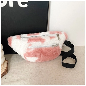Detail of plush cow print fanny pack featuring soft faux fur and dual silver zippers