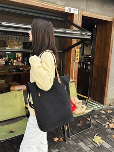 Vintage large black canvas tote bag with brown leather straps and metal rivets for daily wear