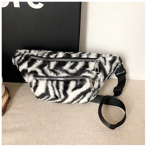 Detail view of fanny pack with zebra faux fur texture and double zipper compartments