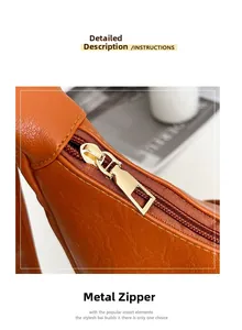 Gros plan de la fermeture éclair dorée sur le sac cabas en cuir orange vif