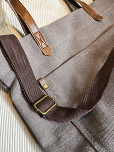 Vintage washed canvas tote bag with brown leather handles and bronze metal hardware