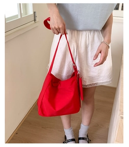 Detail of red canvas tote bag with matching zipper coin purse and wide shoulder strap