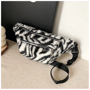 Detail of soft zebra print plush waist bag with dual silver zippers and nylon strap