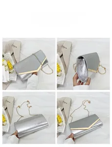 Silver glitter envelope clutch bag with gold V-trim and detachable chain strap detail
