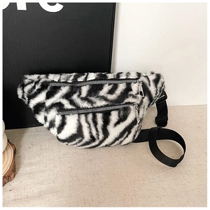 Detail of zebra print faux fur waist bag featuring dual zippers and adjustable strap