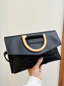 Women's black clutch with crocodile pattern texture and decorative cream D-ring