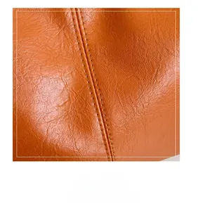 Détail du sac fourre-tout orange en cuir grainé avec coutures doubles renforcées