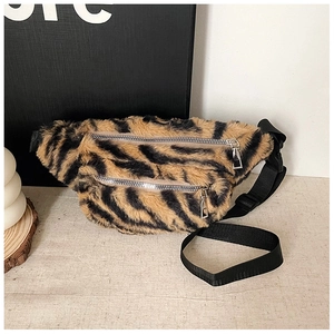 Detail of tiger print teddy fleece fanny pack with silver zippers and adjustable strap
