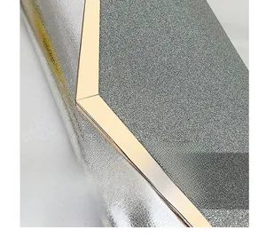 Detailed macro view of silver pebbled leather with champagne gold metallic trim
