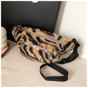 Detail of tiger pattern plush waist bag showing dual silver zippers and soft texture